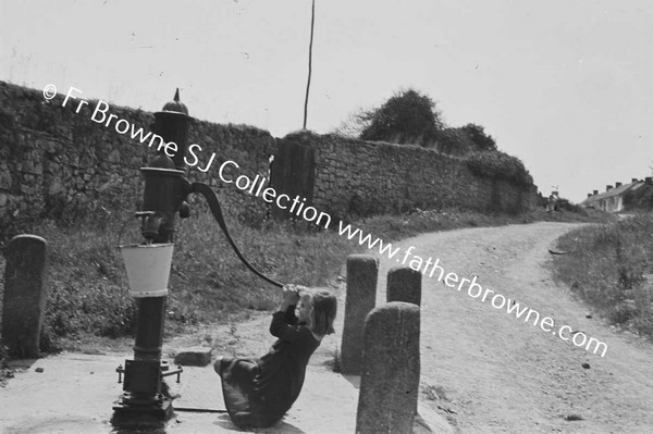 CHILD AT WATER PUMP